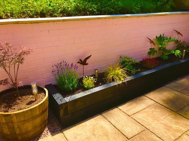 Tidy garden border with colourful plants in Cheltenham